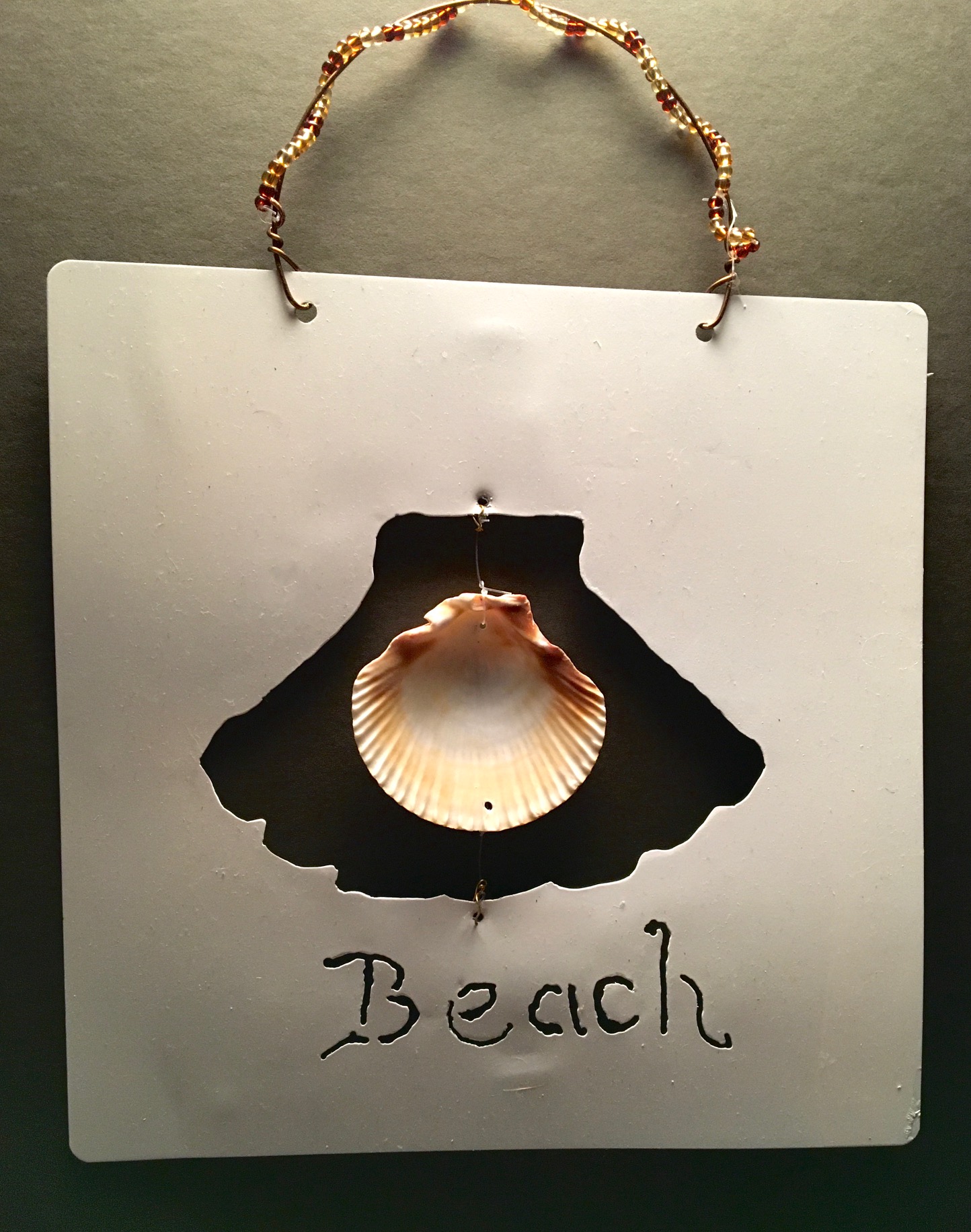 beach sign with a real shell